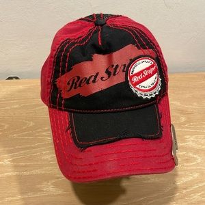 Red Stripe baseball style cap. Adjustable with built in bottle opener